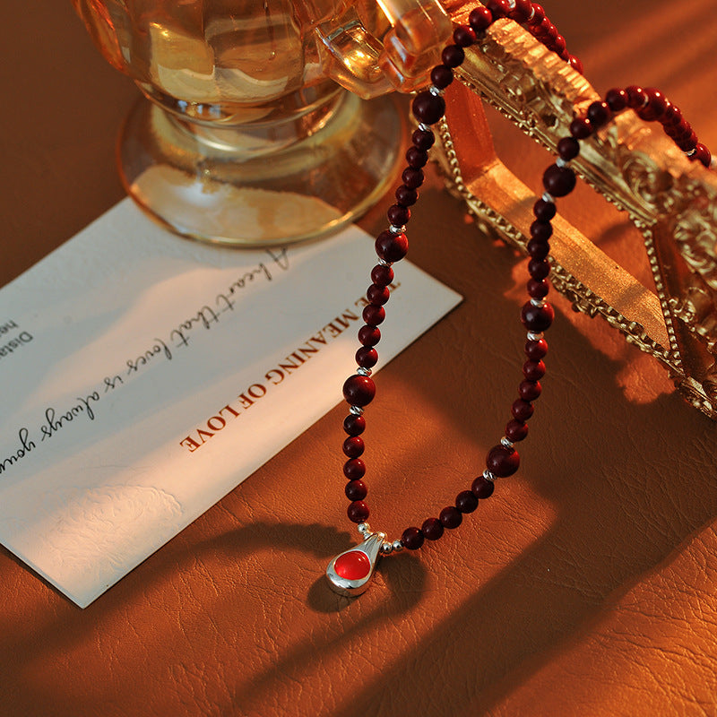Original Niche Design Autumn Winter Wine Red Shijia Glass Bead Necklace for Women Light Luxury High-end Water Drop Pendant Collarbone Chain