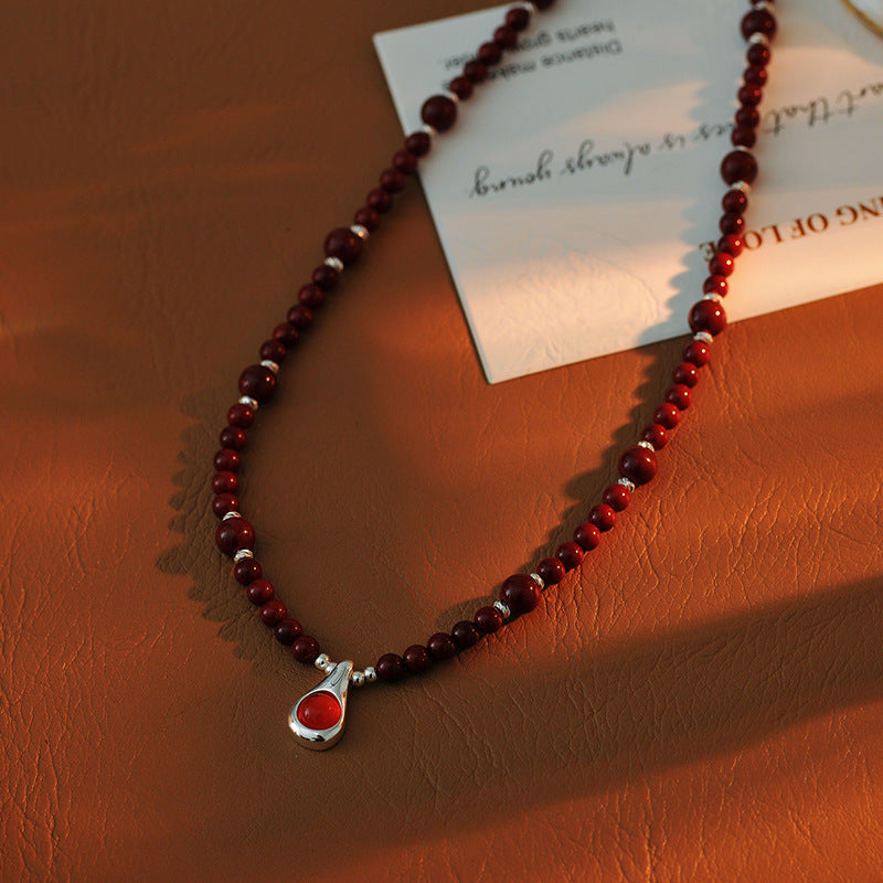 Original Niche Design Autumn Winter Wine Red Shijia Glass Bead Necklace for Women Light Luxury High-end Water Drop Pendant Collarbone Chain